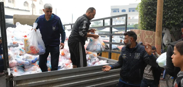 Islamic Relief staff distributing essential hygiene items.