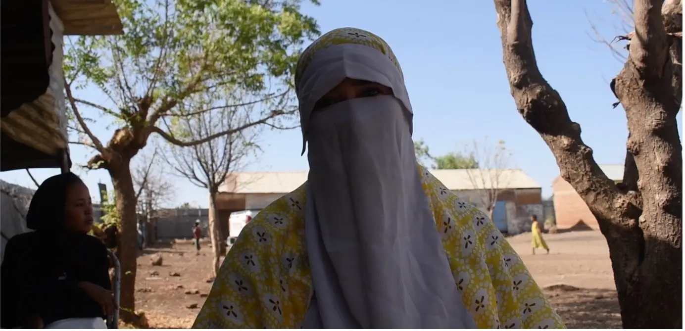 Outside her shelter in Gedaref, Sarah* shares her story of escape, loss, and the struggle to keep her family alive