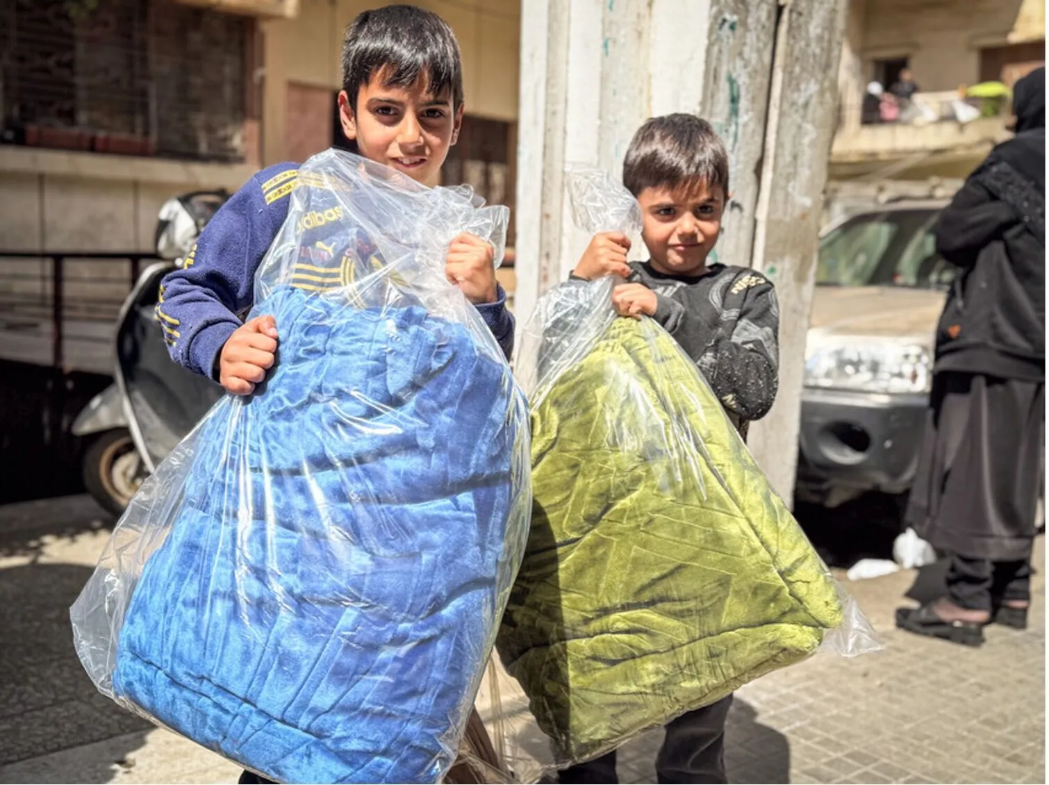 Children collect blankets distributed by Islamic Relief during the emergency response in Lebanon, March 2026