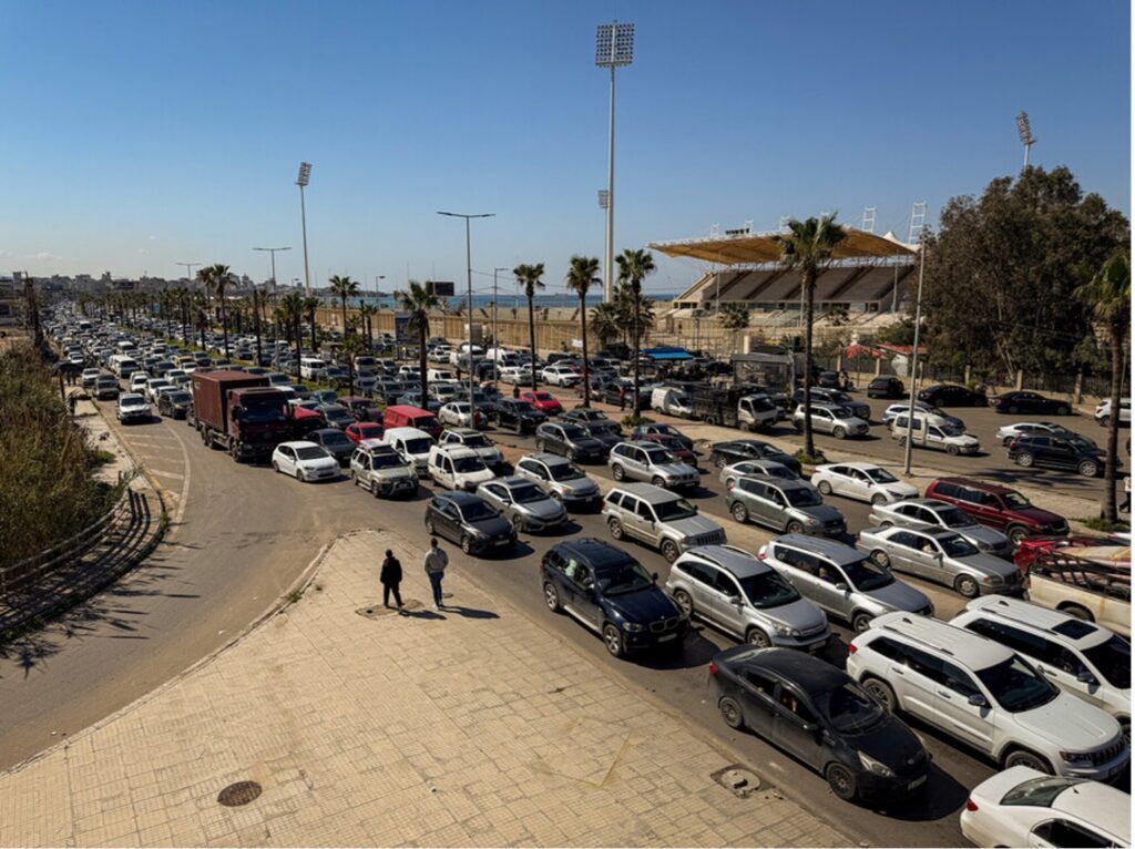 Families flee by car as hostilities escalate across Lebanon, 2026. Many of those on this road had already made this journey once before