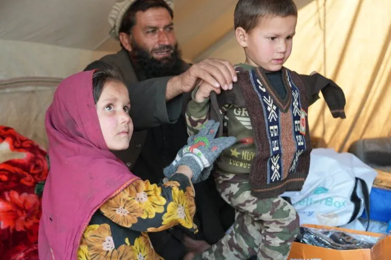 Nazar and his children with donated clothes